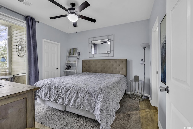 bedroom featuring visible vents, wood finished floors, and a ceiling fan