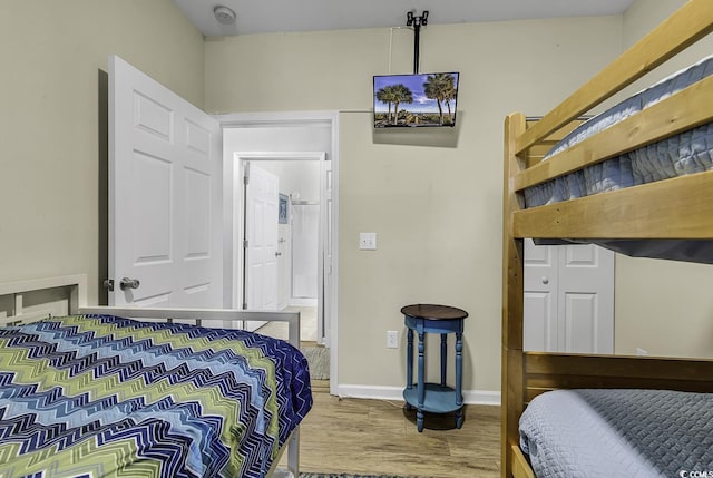 bedroom with baseboards and wood finished floors