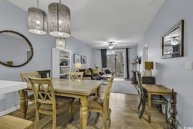 dining space with baseboards, wood finished floors, and ceiling fan