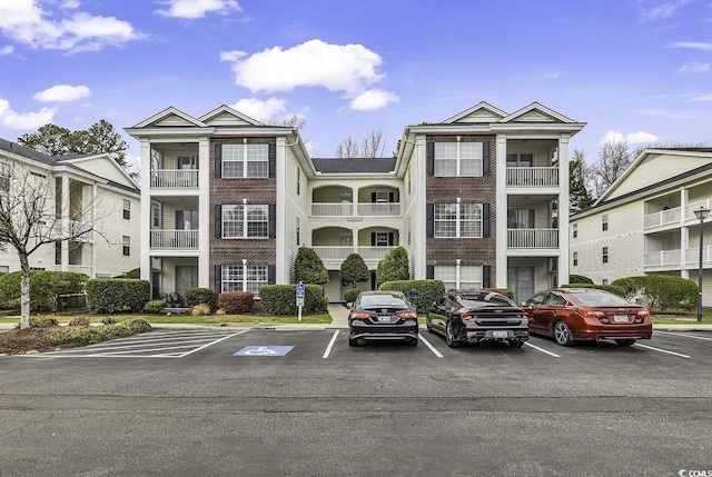 view of building exterior with uncovered parking