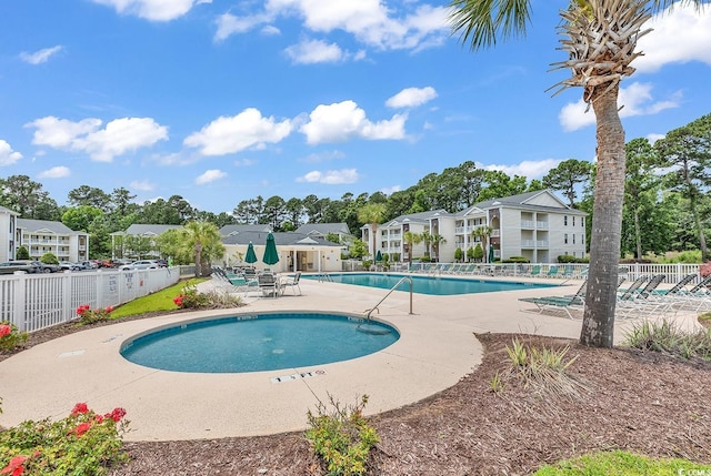 community pool featuring a patio and fence