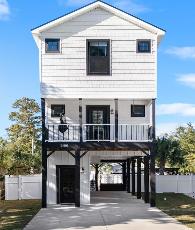 coastal home with a carport and fence