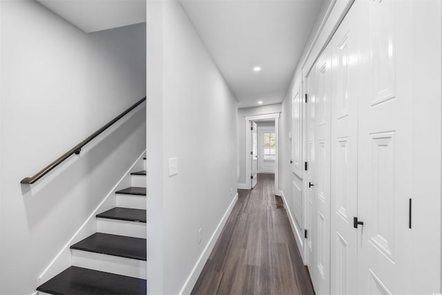 hallway featuring recessed lighting, stairway, baseboards, and dark wood-style floors