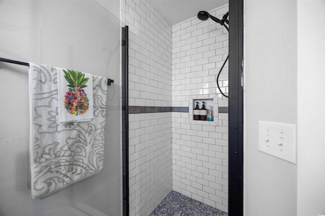 full bath featuring a tile shower