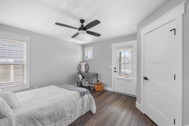 bedroom featuring baseboards, ceiling fan, and dark wood-style flooring