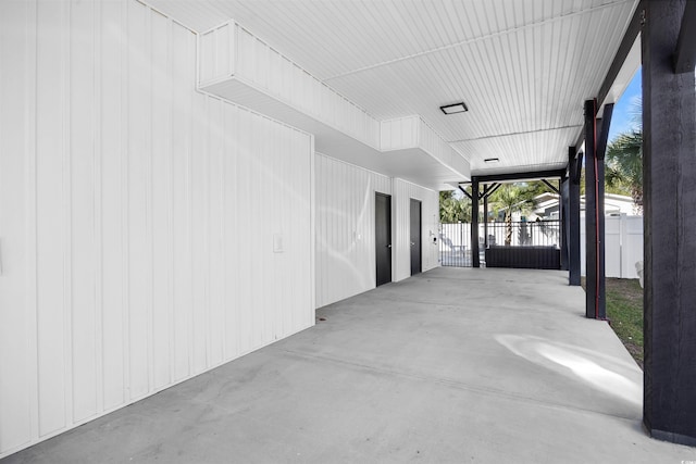 view of patio / terrace featuring an attached carport and fence