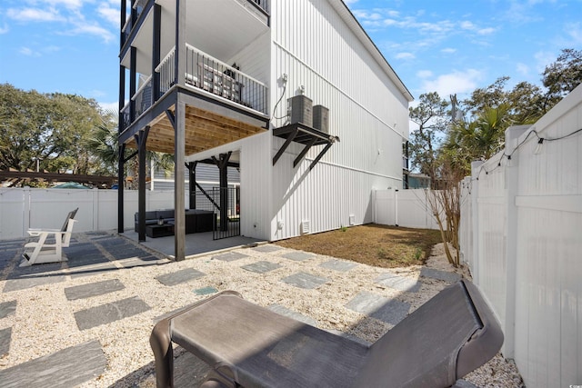 view of patio with a balcony and a fenced backyard