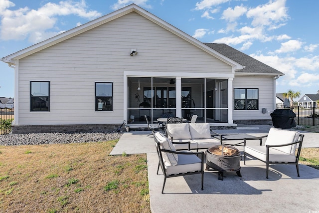 back of house featuring a sunroom, fence, a lawn, and a patio area