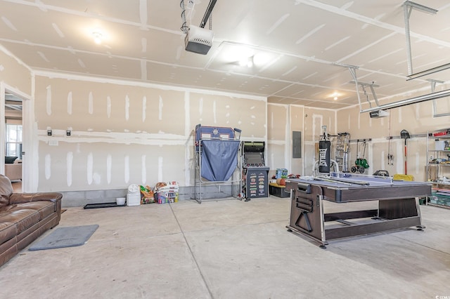 garage with electric panel and a garage door opener