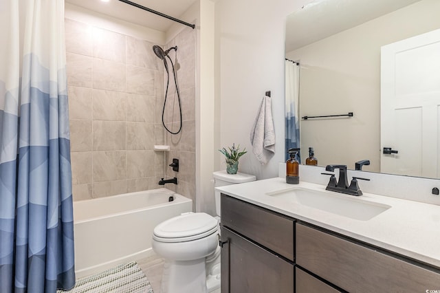 bathroom featuring toilet, shower / tub combo with curtain, and vanity