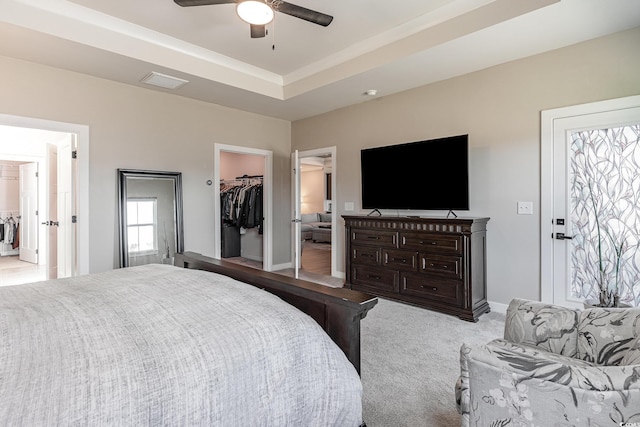 bedroom featuring visible vents, baseboards, carpet, a raised ceiling, and a spacious closet