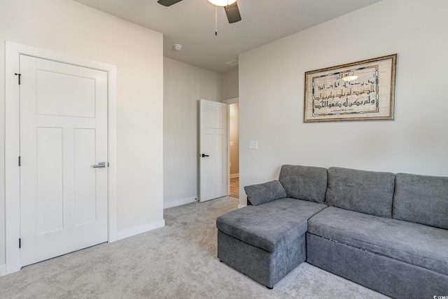 living area with baseboards, carpet, and ceiling fan