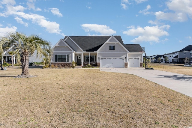 craftsman-style home featuring driveway, a front lawn, stone siding, a residential view, and an attached garage