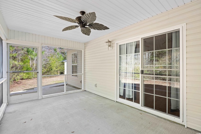 unfurnished sunroom with a ceiling fan