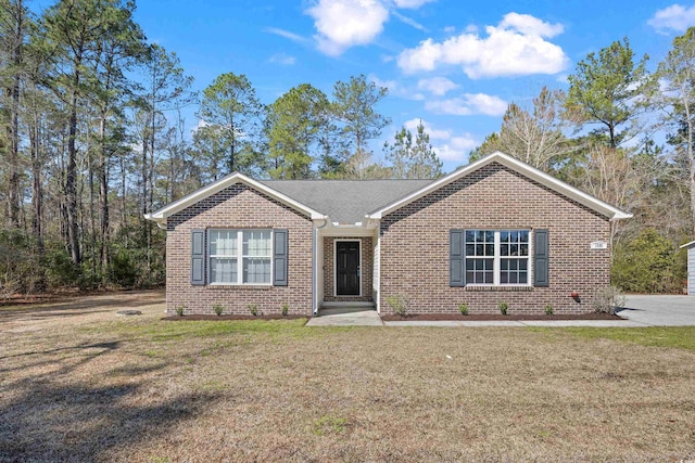 single story home with brick siding and a front yard