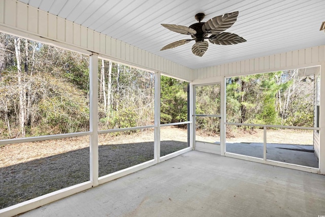 unfurnished sunroom with ceiling fan