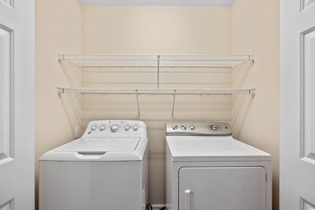 washroom featuring laundry area and washer and clothes dryer