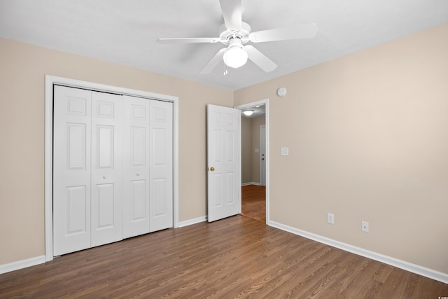 unfurnished bedroom with a closet, a ceiling fan, baseboards, and wood finished floors