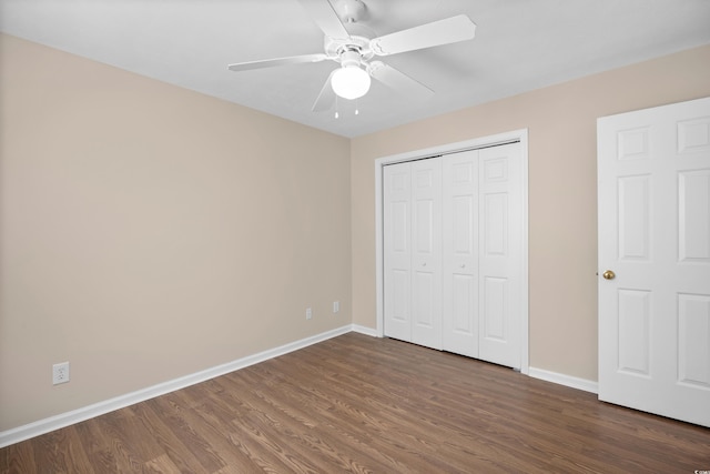 unfurnished bedroom with wood finished floors, baseboards, a closet, and ceiling fan