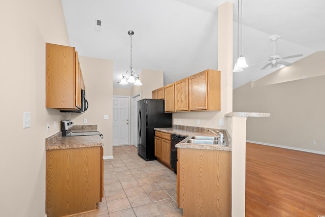 kitchen with hanging light fixtures, ceiling fan with notable chandelier, black appliances, and baseboards