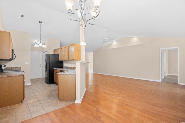 kitchen with lofted ceiling, light wood-style flooring, black appliances, ceiling fan with notable chandelier, and open floor plan