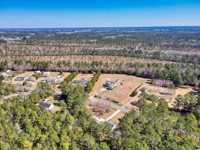 birds eye view of property with a view of trees and a rural view