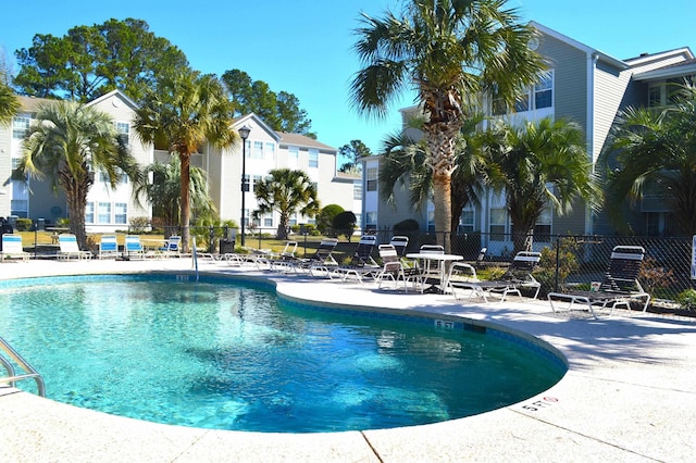 140 Spanish Oak Ct Unit 1, Surfside Beach, SC 29575 - community pool with fence, a patio area, and a residential view