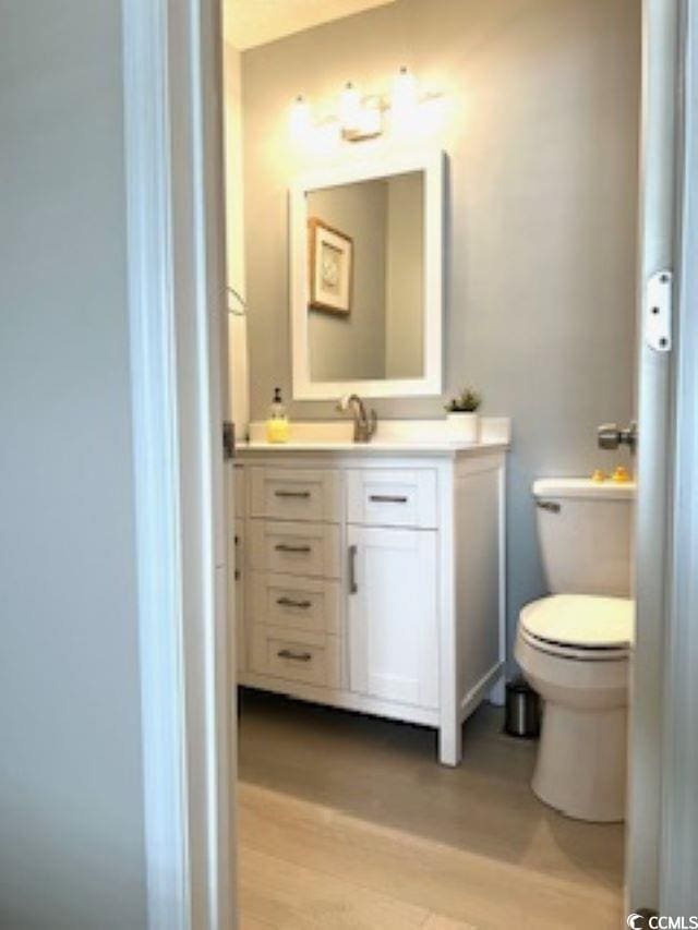 140 Spanish Oak Ct Unit 1, Surfside Beach, SC 29575 - bathroom featuring wood finished floors, vanity, and toilet