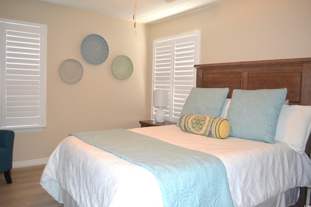 bedroom with wood finished floors and baseboards