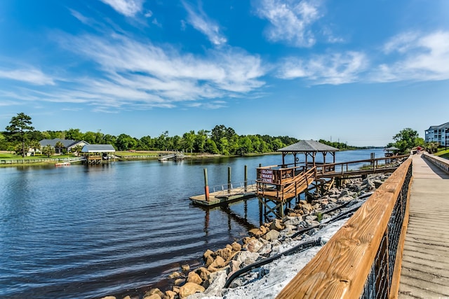 view of dock featuring a gazebo and a water view