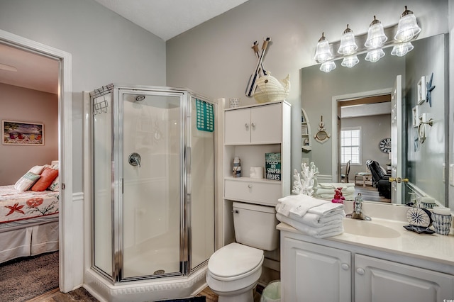 ensuite bathroom with a stall shower, toilet, ensuite bath, and vanity