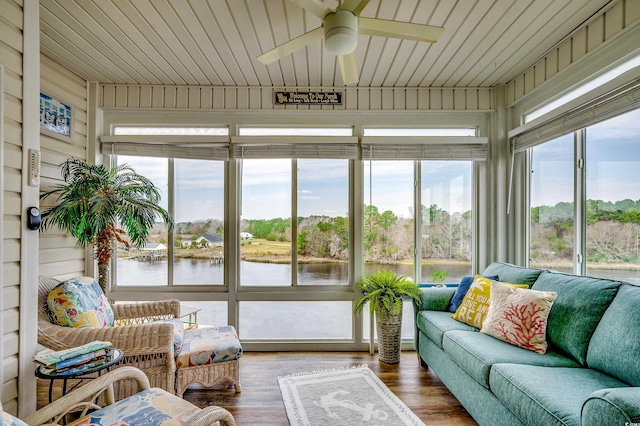 sunroom / solarium with a water view, a healthy amount of sunlight, and ceiling fan