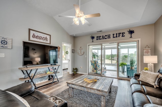 living area with vaulted ceiling, wood finished floors, visible vents, and ceiling fan