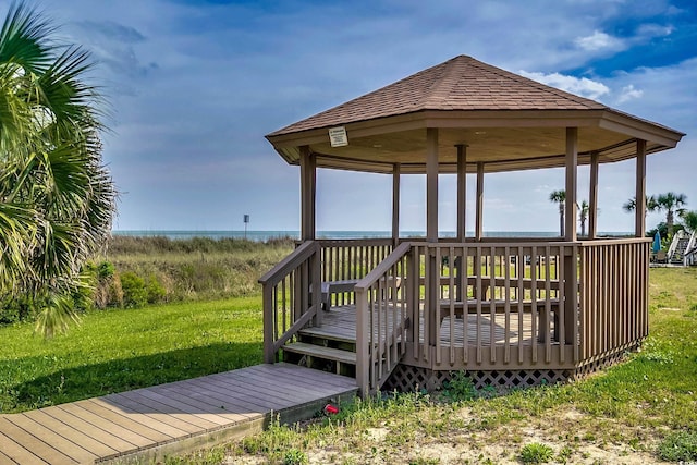 wooden terrace with a gazebo and a lawn