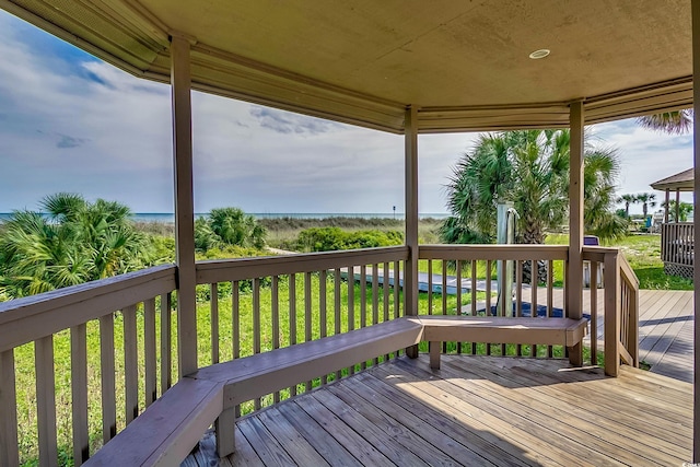 wooden deck with a lawn