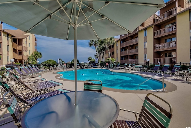 pool featuring a patio and fence