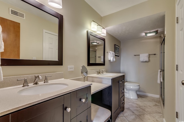 full bathroom with a sink, visible vents, toilet, and two vanities