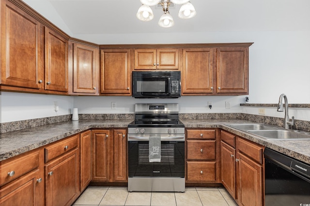 kitchen featuring black appliances, a sink, dark countertops, an inviting chandelier, and light tile patterned flooring