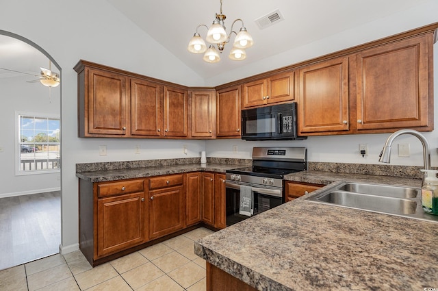 kitchen with light tile patterned floors, visible vents, stainless steel electric stove, a sink, and black microwave