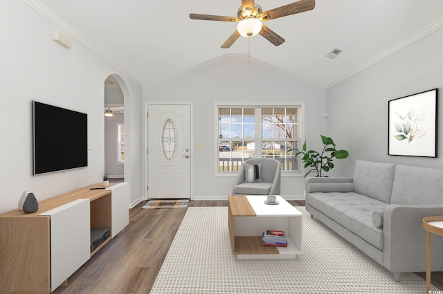 living room featuring wood finished floors, visible vents, ceiling fan, vaulted ceiling, and crown molding