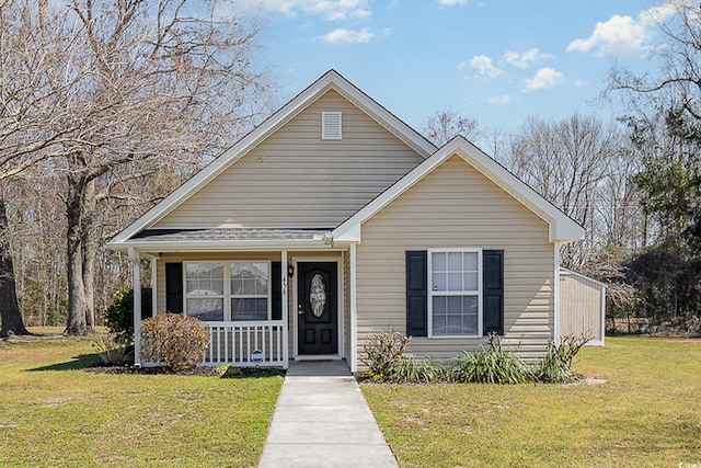 bungalow with a porch and a front lawn