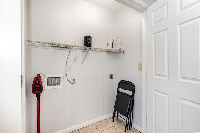 washroom with light tile patterned floors, baseboards, hookup for an electric dryer, hookup for a washing machine, and laundry area