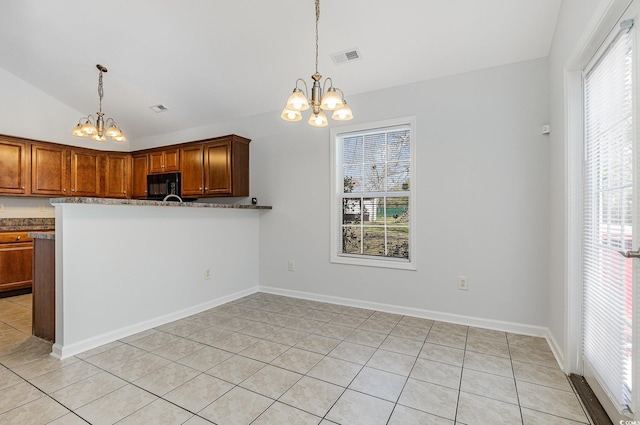 kitchen featuring decorative light fixtures, an inviting chandelier, black microwave, and vaulted ceiling