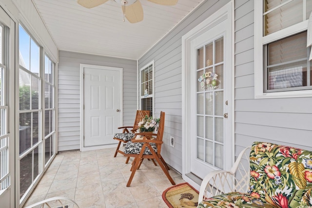 sunroom featuring ceiling fan