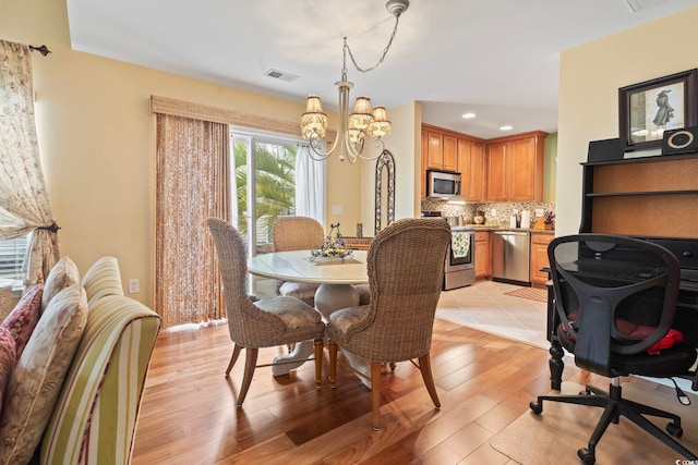 dining area featuring a chandelier, visible vents, recessed lighting, and light wood finished floors