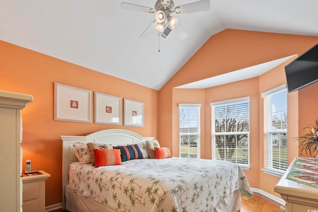 bedroom with baseboards, wood finished floors, a ceiling fan, and vaulted ceiling