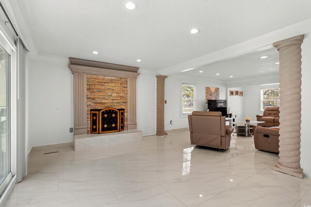 3763 Annandale Dr, Myrtle Beach, SC 29577 - living room featuring a stone fireplace, marble finish floor, crown molding, and decorative columns