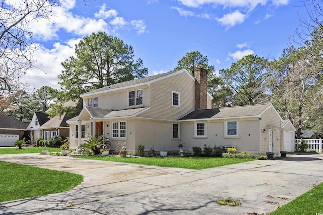 3763 Annandale Dr, Myrtle Beach, SC 29577 - view of front facade featuring stucco siding, driveway, a front yard, a garage, and a chimney