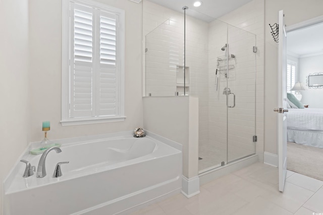 ensuite bathroom featuring a bath, a shower stall, tile patterned floors, and ensuite bathroom