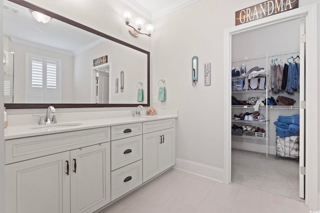 bathroom with double vanity, visible vents, ornamental molding, and a sink